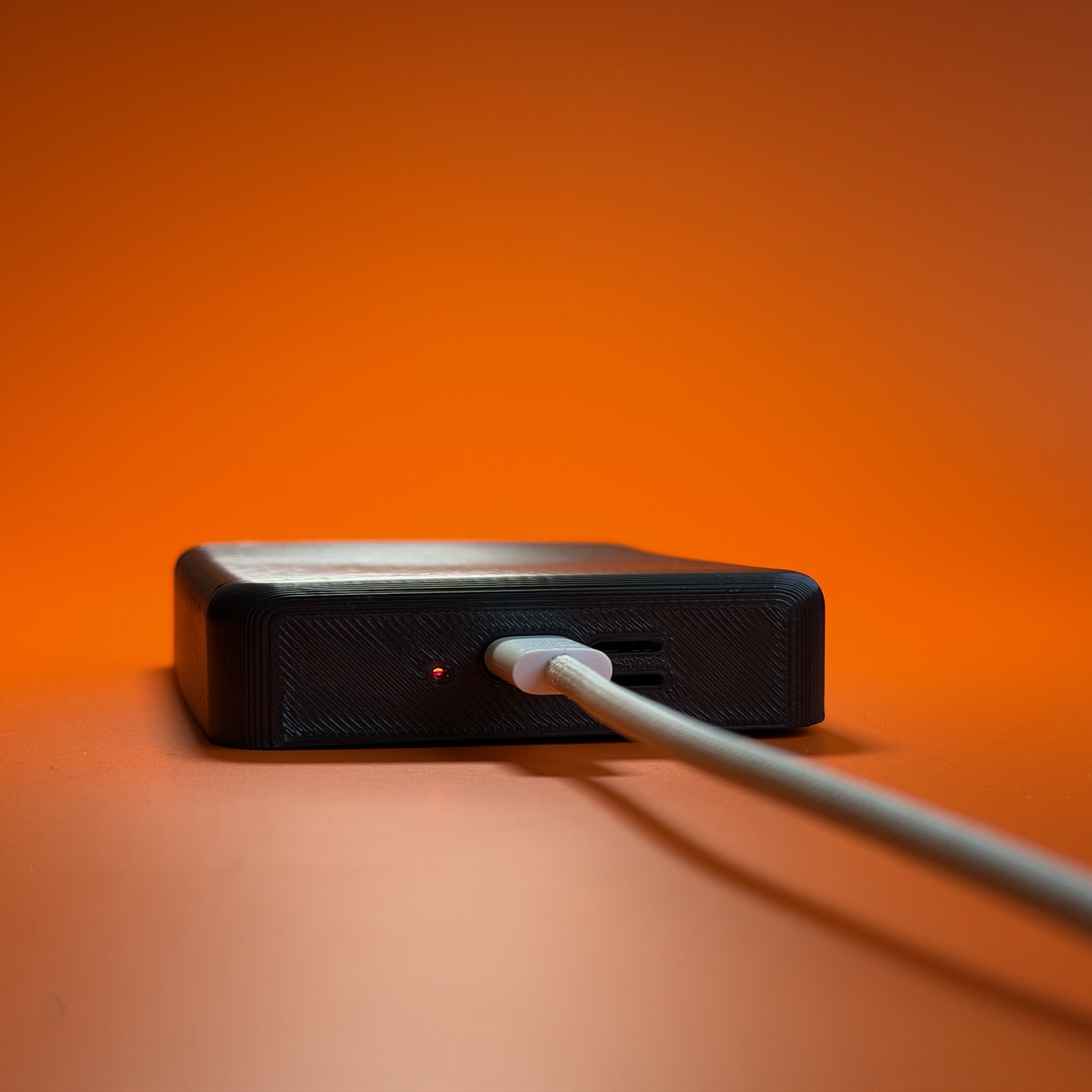 Beacon 2 charging over USB-C with the charge light lit